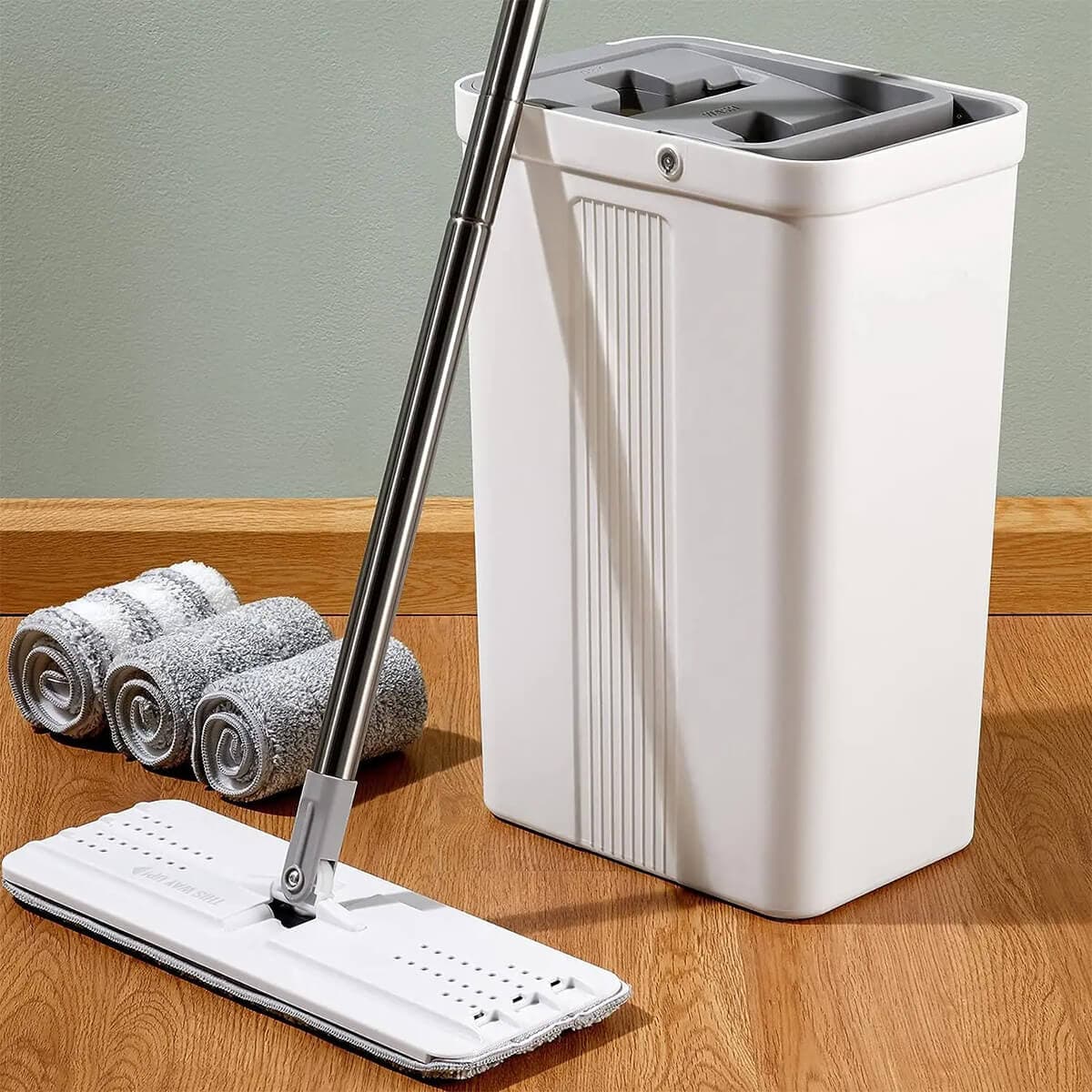 Self-wringing mop bucket set with white bucket and stainless steel handle on hardwood floor